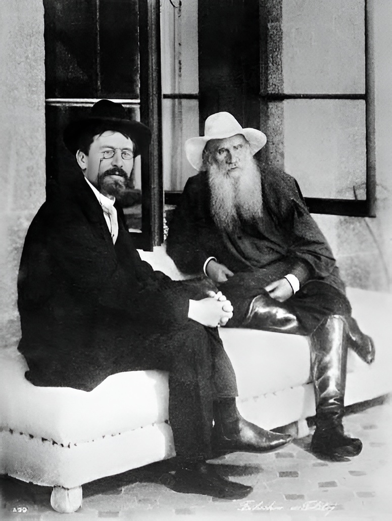 Anton Chekhov and Leo Tolstoy seated together on a bench outside a house in Yalta